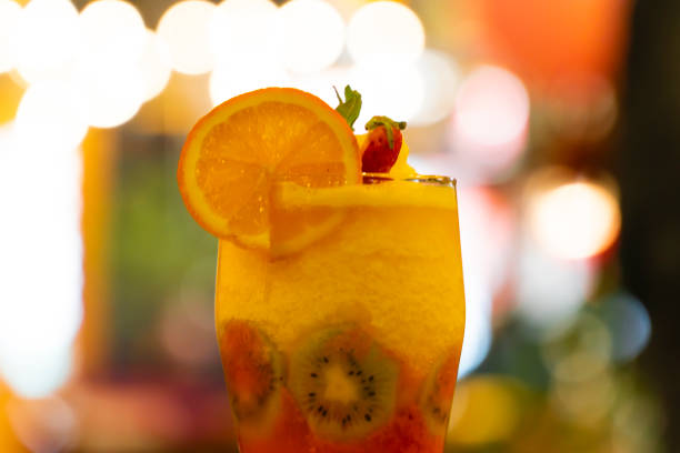 Cold sweet summer fruit juice cocktail glass.
